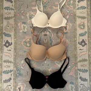 Victoria’s Secret PINK bras in black, cream, and white